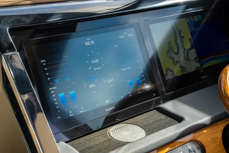 Slide: The Image of Dashboard of 2024 Chris-Craft Calypso 35 CP with navigation and control screens. - 24