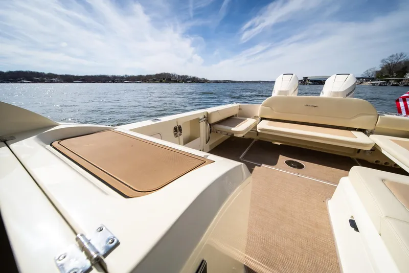 Slide: The Image of 2024 Chris-Craft Calypso 35 CP boat on a sunny lake, showcasing spacious deck. - 29