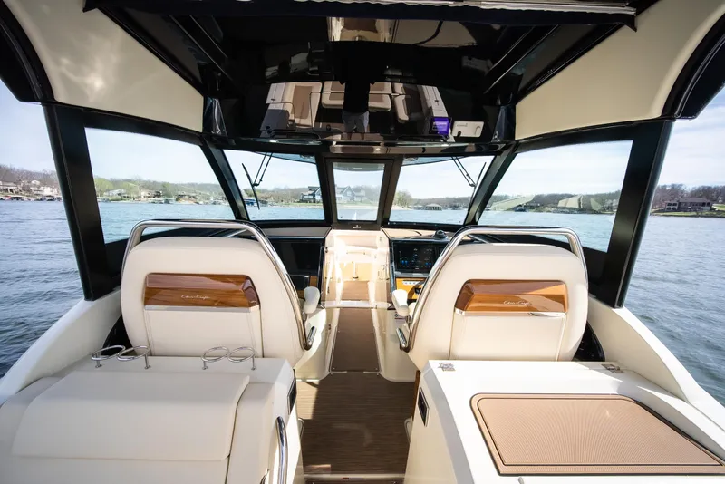 Slide: The Image of 2024 Chris-Craft Calypso 35 CP interior, featuring luxurious seating and modern dashboard on the water. - 31