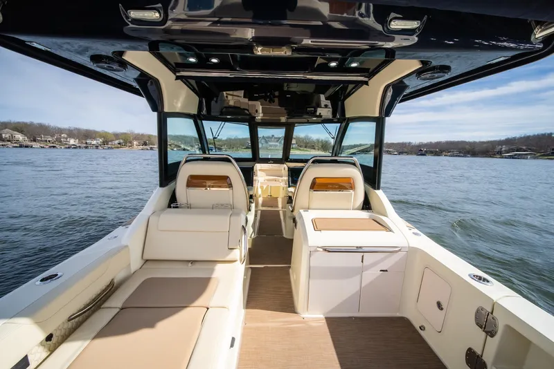 Slide: The Image of 2024 Chris-Craft Calypso 35 CP boat interior with luxurious seating on a serene lake. - 32
