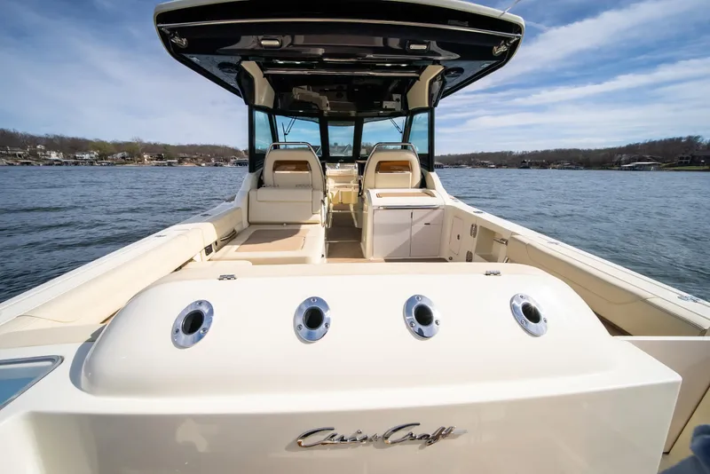 Slide: The Image of 2024 Chris-Craft Calypso 35 CP boat on a lake, showcasing luxury seating and sleek design. - 33