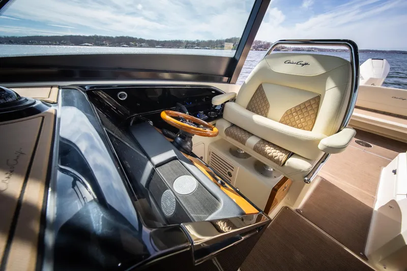 Slide: The Image of 2024 Chris-Craft Calypso 35 CP helm with luxurious seating and elegant steering wheel. - 35
