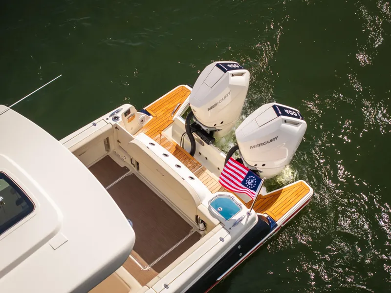 Slide: The Image of 2024 Chris-Craft Calypso 35 CP boat with dual Mercury engines and American flag. - 4