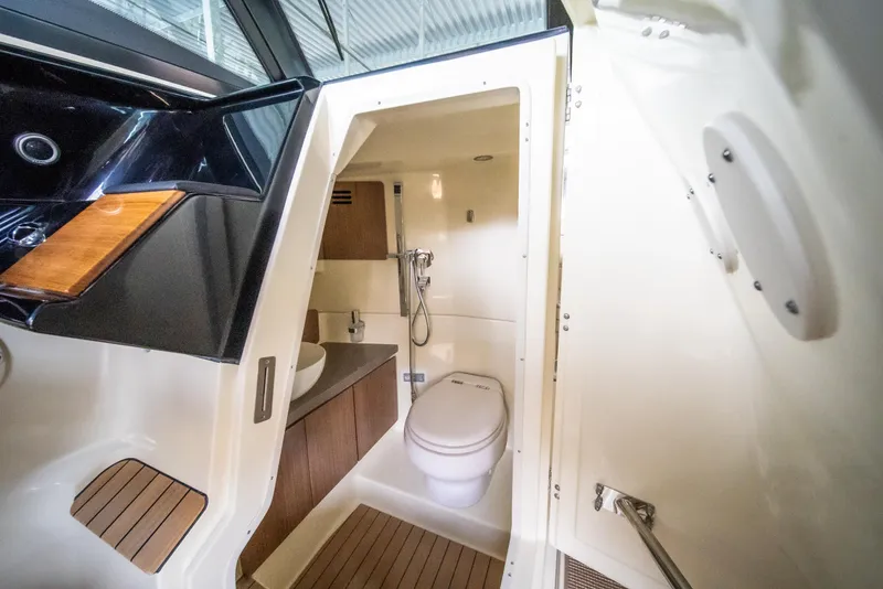 Slide: The Image of 2024 Chris-Craft Calypso 35 CP boat interior bathroom with modern fixtures and wooden accents. - 42