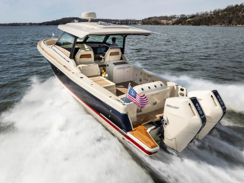 Slide: The Image of 2024 Chris-Craft Calypso 35 CP cruising on water with dual Mercury engines. - 45