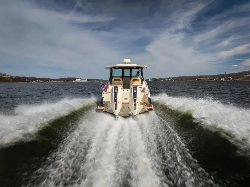 Slide: The Image of 2024 Chris-Craft Calypso 35 CP cruising on open water, rear view. - 6