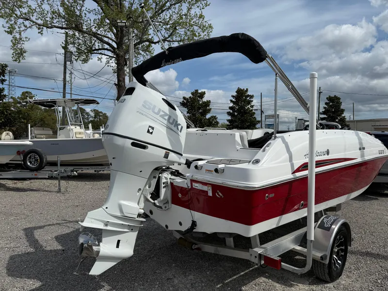 Slide: The Image of 2023 Hurricane SunDeck Sport 188 OB boat with Suzuki outboard motor on trailer. - 12