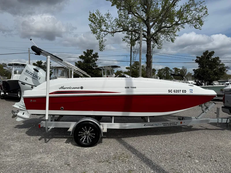 Slide: The Image of 2023 Hurricane SunDeck Sport 188 OB boat on trailer, red and white design. - 13