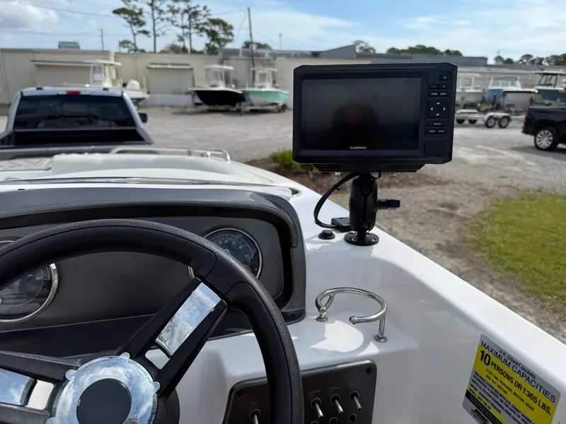 Slide: The Image of 2023 Hurricane SunDeck Sport 188 OB dashboard with steering wheel and mounted Garmin display. - 28