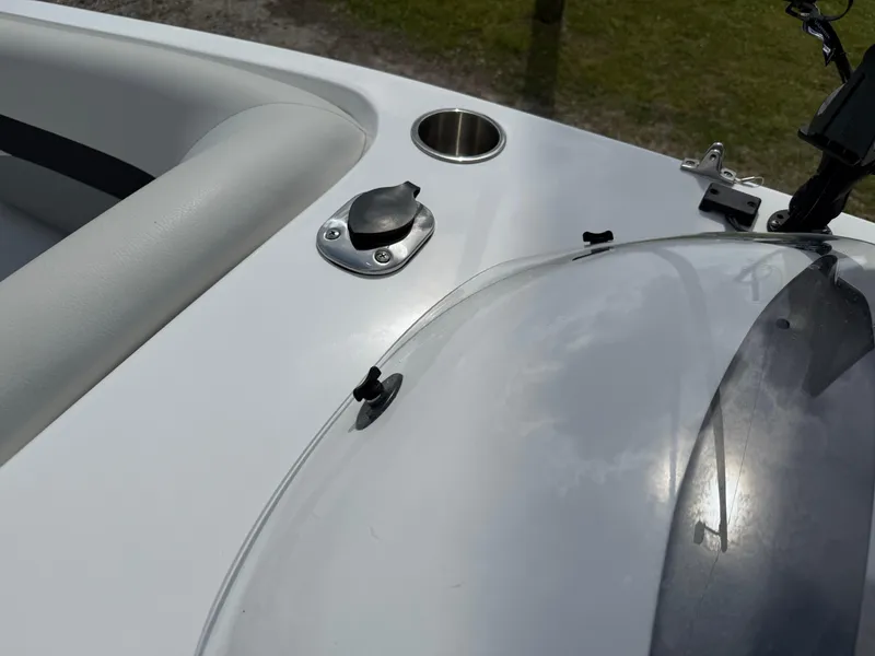 Slide: The Image of 2023 Hurricane SunDeck Sport 188 OB boat dashboard with cup holder and windshield detail. - 29