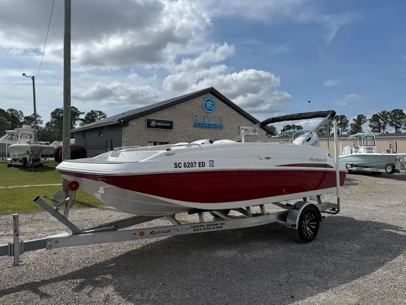 Slide: The Image of 2023 Hurricane SunDeck Sport 188 OB boat on trailer, parked outdoors. - 6