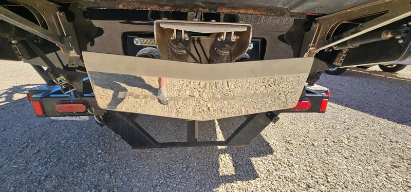 Slide: The Image of Rear view of 2013 Malibu Wakesetter 23 MXZ boat trailer on gravel surface. - 13