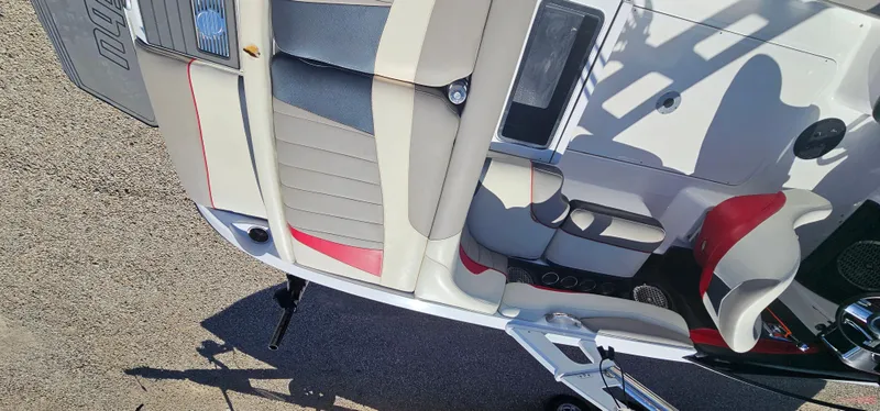 Slide: The Image of Interior view of a 2013 Malibu Wakesetter 23 MXZ boat with red and gray seating. - 17