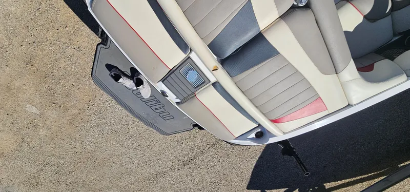 Slide: The Image of 2013 Malibu Wakesetter 23 MXZ boat interior with beige and gray seating. - 18