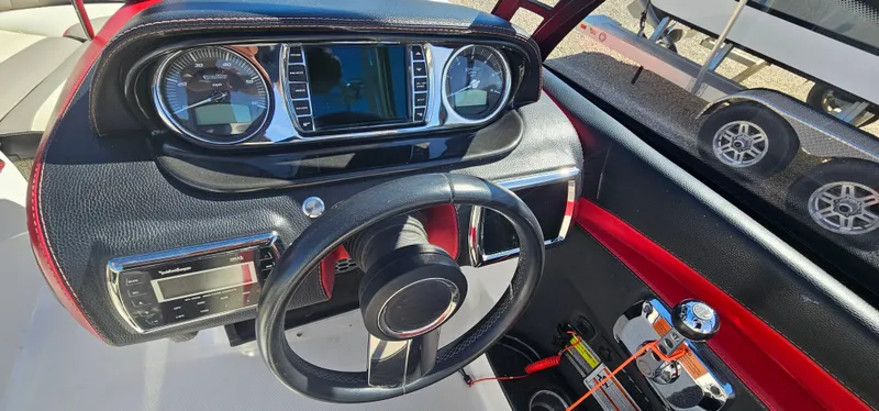 Slide: The Image of Dashboard of 2013 Malibu Wakesetter 23 MXZ boat with steering wheel and controls. - 26