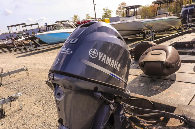 Slide: The Image of 2015 Ranger RT178 with Yamaha outboard motor in a boatyard setting. - 12