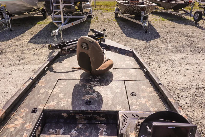 Slide: The Image of 2015 Ranger RT178 fishing boat with camo deck and seat, parked on gravel. - 16