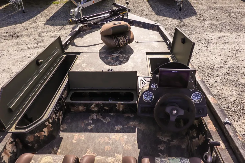 Slide: The Image of 2015 Ranger RT178 boat interior with storage compartments and steering console. - 17