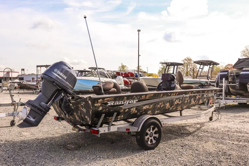 Slide: The Image of 2015 Ranger RT178 boat with Yamaha motor on a trailer in a parking lot. - 3