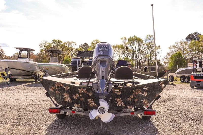 Slide: The Image of 2015 Ranger RT178 boat with camouflage design, parked in a lot with other boats. - 4