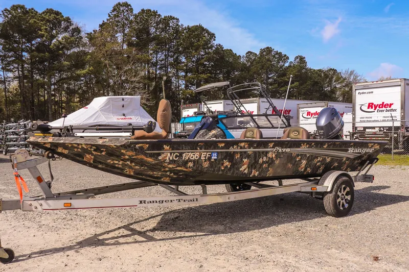 Slide: The Image of 2015 Ranger RT178 boat on trailer, camo design, parked outdoors. - 7