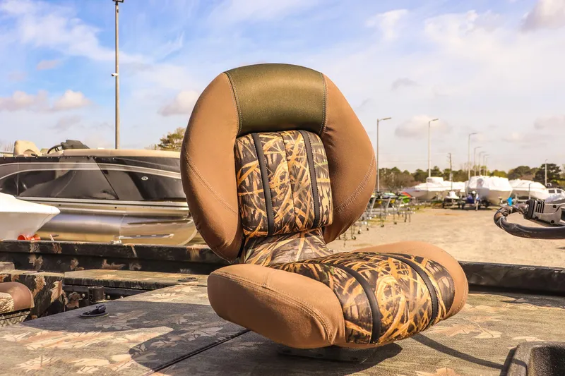 Slide: The Image of Camo-patterned seat on 2015 Ranger RT178 boat, outdoors with other boats in background. - 9