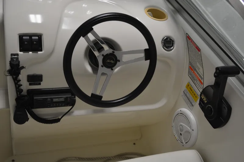 Slide: The Image of Steering wheel and controls of a 1997 Sea Ray 240 Sundancer boat. - 13