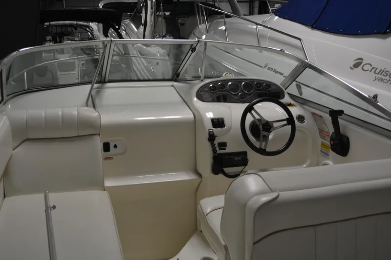 Slide: The Image of 1997 Sea Ray 240 Sundancer boat interior with steering wheel and seating area. - 15