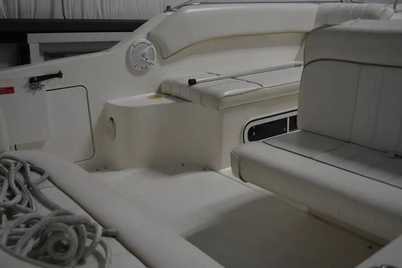Slide: The Image of 1997 Sea Ray 240 Sundancer boat interior with white seating and storage compartments. - 16