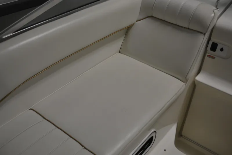 Slide: The Image of 1997 Sea Ray 240 Sundancer interior seating, beige upholstery, comfortable design. - 17