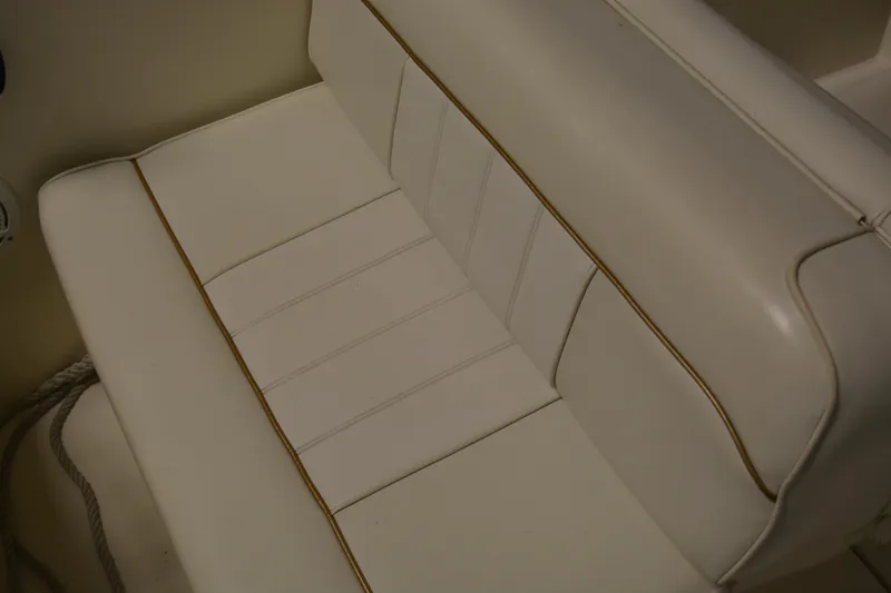 Slide: The Image of White leather seating on 1997 Sea Ray 240 Sundancer boat, showcasing elegant design and comfort. - 18