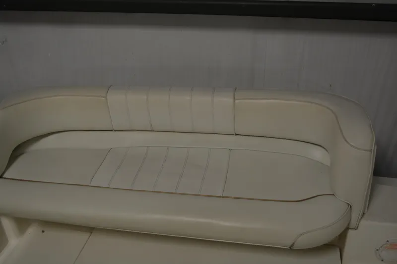 Slide: The Image of 1997 Sea Ray 240 Sundancer boat interior with white leather seating. - 19