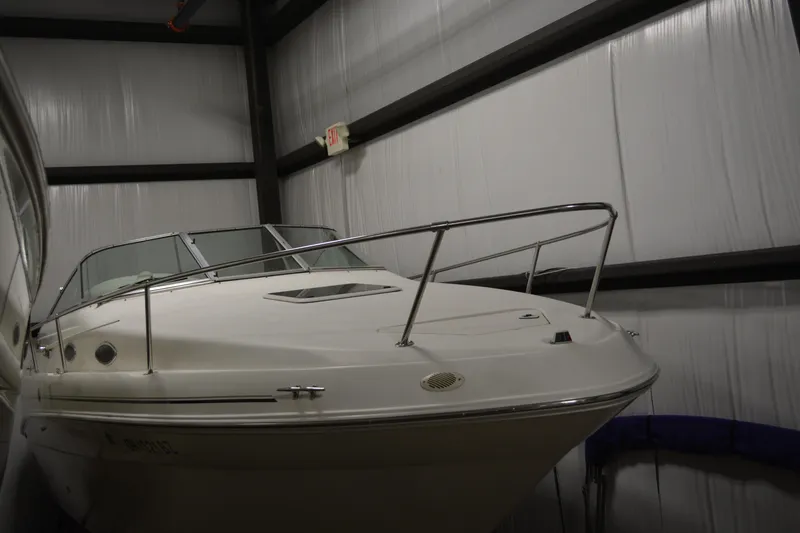 Slide: The Image of 1997 Sea Ray 240 Sundancer boat in indoor storage facility. - 2