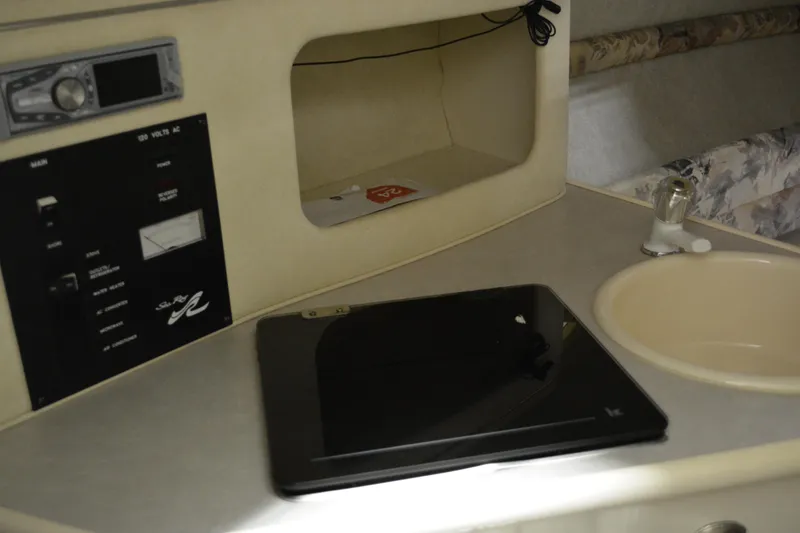 Slide: The Image of Interior of 1997 Sea Ray 240 Sundancer with control panel and sink. - 27