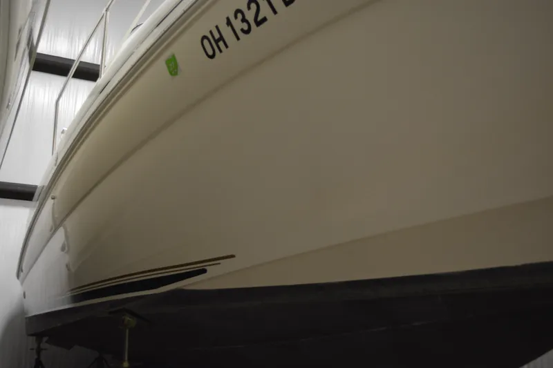 Slide: The Image of 1997 Sea Ray 240 Sundancer boat in storage, side view. - 3