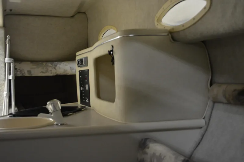 Slide: The Image of Interior cabin of 1997 Sea Ray 240 Sundancer boat, featuring beige upholstery and compact design. - 30