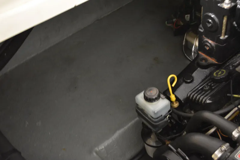 Slide: The Image of Engine compartment of a 1997 Sea Ray 240 Sundancer boat, showing mechanical components. - 36