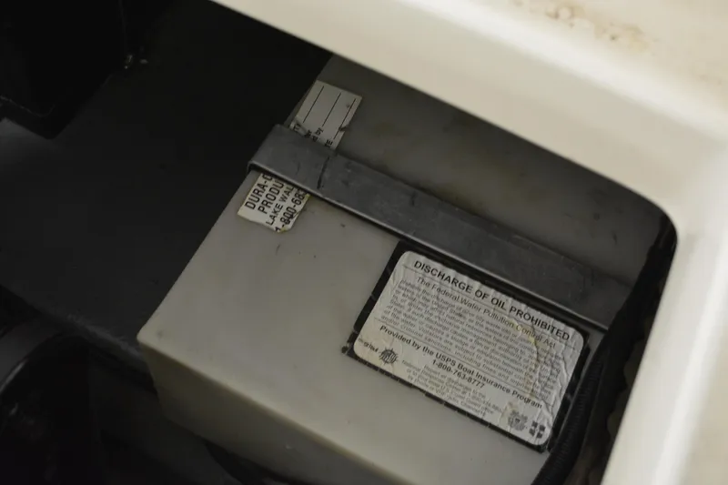 Slide: The Image of Battery compartment of a 1997 Sea Ray 240 Sundancer boat with safety labels. - 38