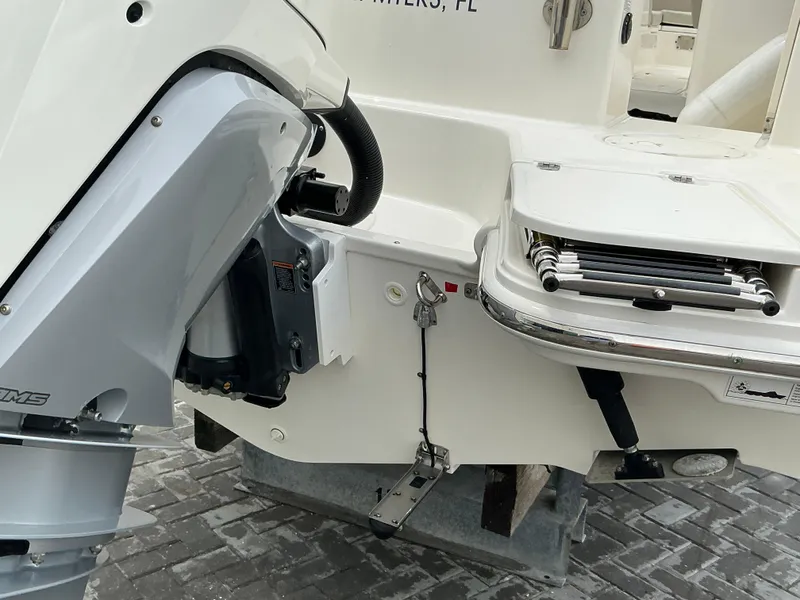Slide: The Image of 2023 Boston Whaler 240 Vantage boat stern with motor and swim ladder. - 10