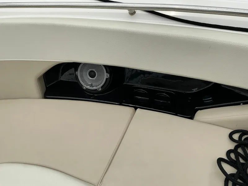 Slide: The Image of 2023 Boston Whaler 240 Vantage interior with beige seating and speaker detail. - 29