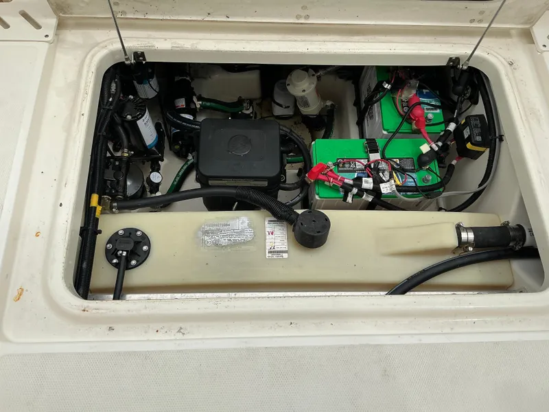 Slide: The Image of 2023 Boston Whaler 240 Vantage engine compartment with battery and wiring. - 30