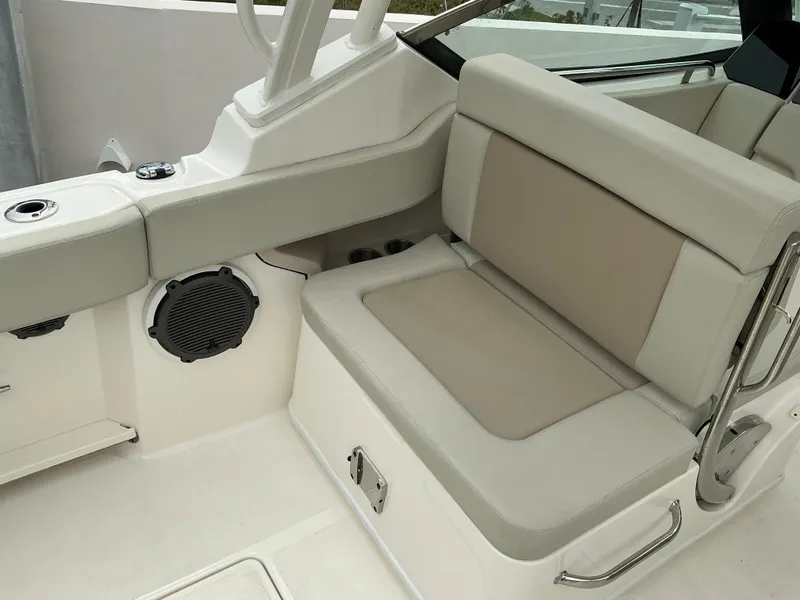 Slide: The Image of 2023 Boston Whaler 240 Vantage boat interior with beige seating and speaker. - 31
