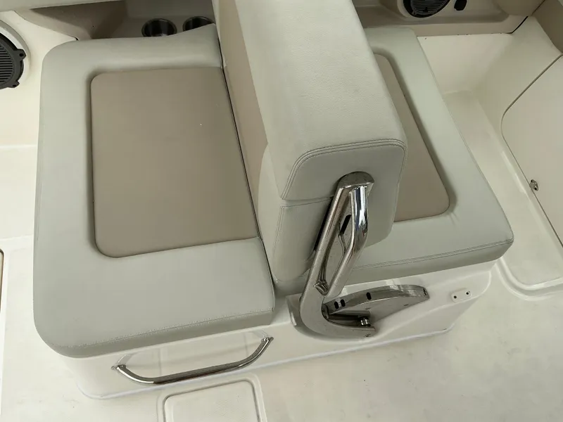 Slide: The Image of 2023 Boston Whaler 240 Vantage boat seat with beige upholstery and chrome handle. - 36