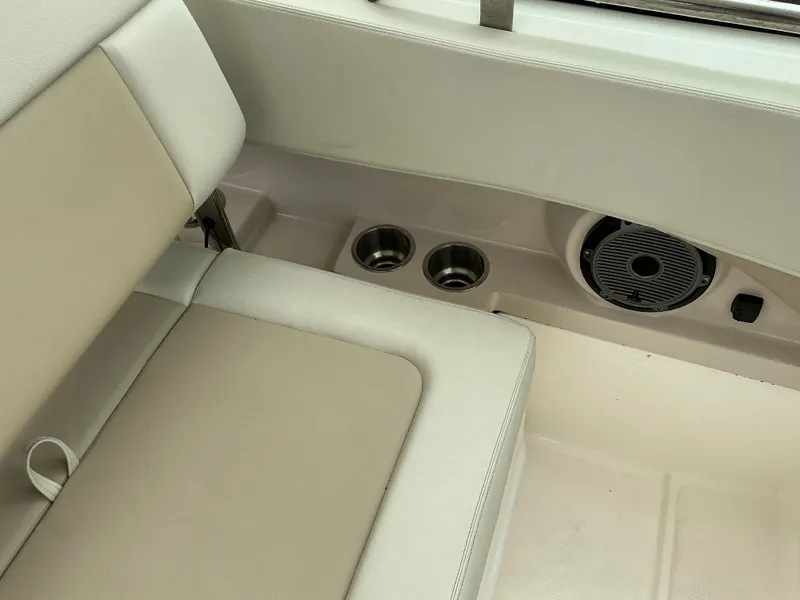 Slide: The Image of 2023 Boston Whaler 240 Vantage interior with beige seating and cup holders. - 37