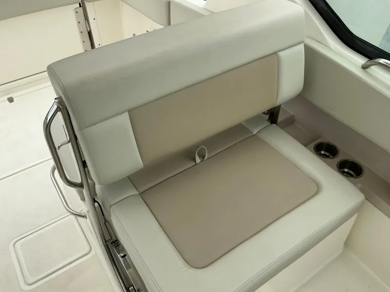 Slide: The Image of 2023 Boston Whaler 240 Vantage boat seat with beige and cream upholstery. - 38