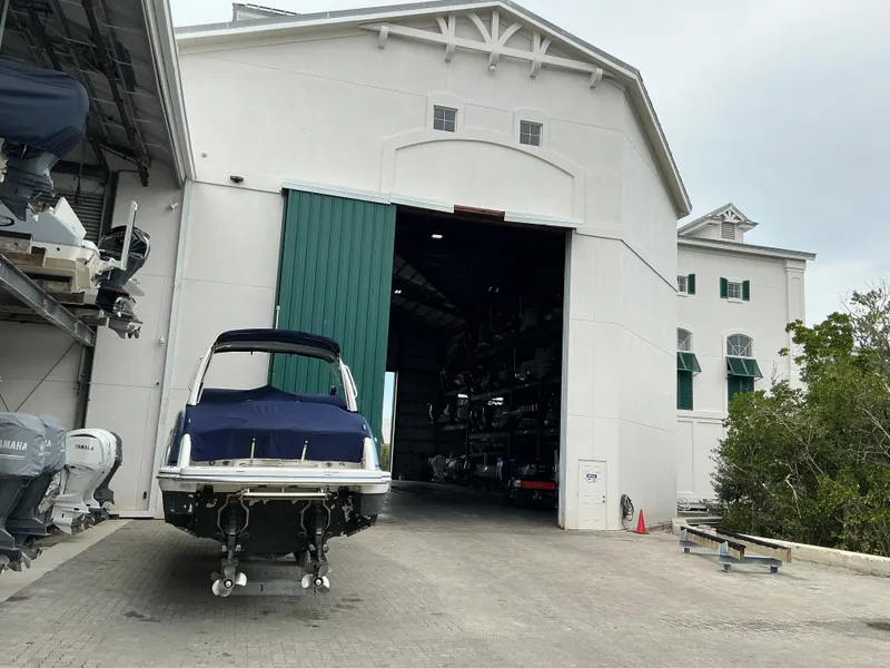 Slide: The Image of 2023 Boston Whaler 240 Vantage boat outside large storage facility. - 43