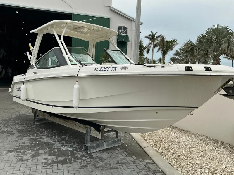 Slide: The Image of 2023 Boston Whaler 240 Vantage boat on display outside a building. - 5