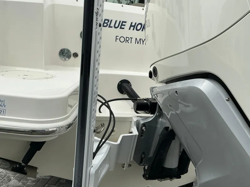 Slide: The Image of 2023 Boston Whaler 240 Vantage boat stern with motor and "Blue Home" text. - 9