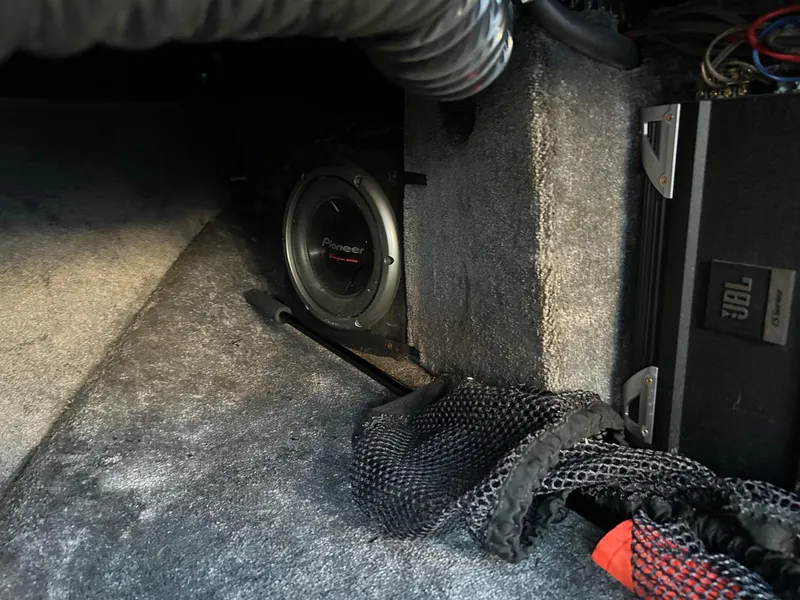 Slide: The Image of Interior of a 1999 Toyota Epic 21 featuring a Pioneer subwoofer and JBL audio system. - 12