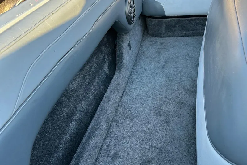 Slide: The Image of Interior of a 1999 Toyota Epic 21, featuring gray carpet and speaker detail. - 15